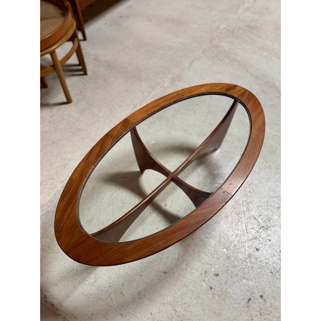 Beautiful oval teak “Astro” coffee table by Victor Wilkins for GPlan, Attributed circa 1960s. Sculptural lines meet warm...