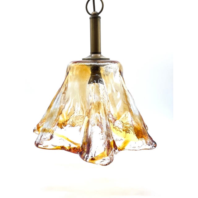 An exceptional mid-century pendant lamp, distinguished by its organic form and masterful glasswork. It is a solid piece of...
