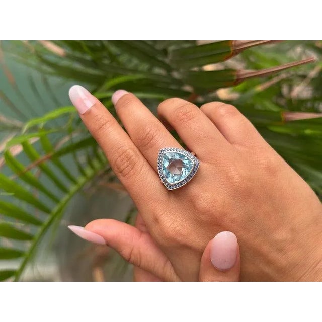 This Antique Style Faceted Trillion Natural Topaz & Sapphire Cocktail Silver Ring statement cocktail ring showcases a...