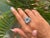 This Antique Style Faceted Trillion Natural Topaz & Sapphire Cocktail Silver Ring statement cocktail ring showcases a...