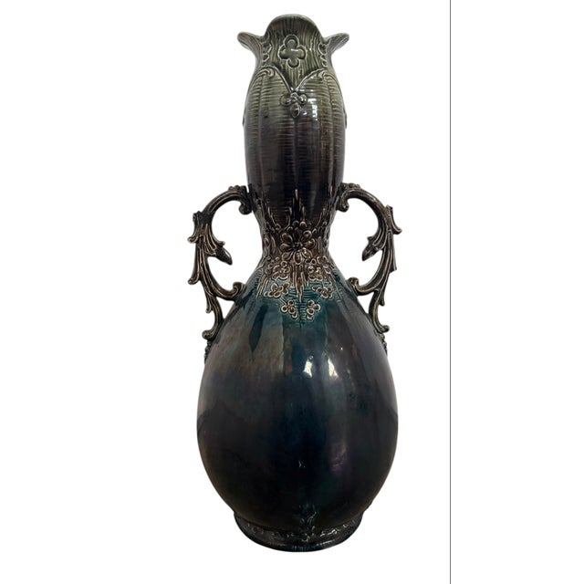 9 1/2”W x 18”H x 8”D This early 20th-century French Art Nouveau vase is a prime example of Barbotine majolica earthenware....