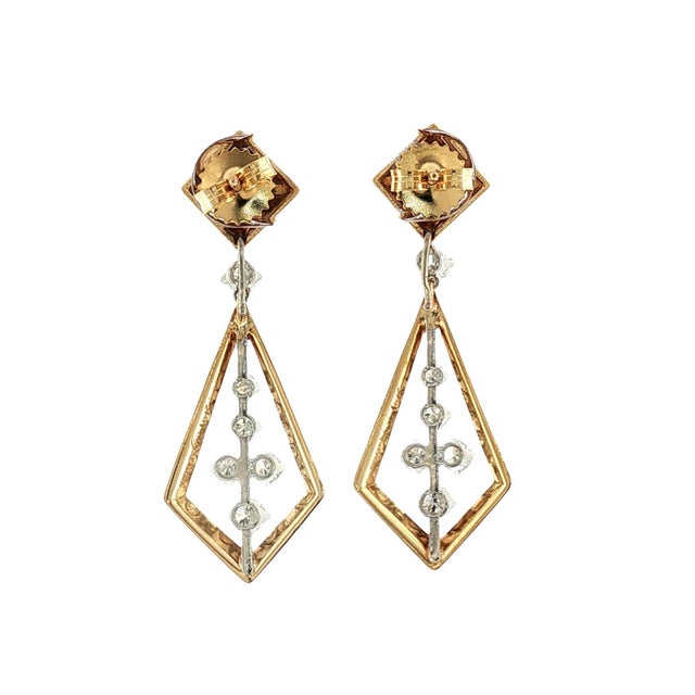 A pair of 18k gold and platinum diamond drop earrings. Featuring 12 round white diamonds with a total carat weight of...