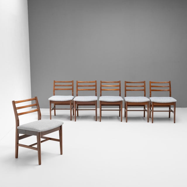 Set of six mid-century dining chairs in solid teak, re-polished and newly covered in a pale blue fabric. U.K circa 1960.