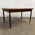 A clean Danish teak dining table from the 1960s with a warm rectangular top, gently shaped edge detail, and tapered legs....