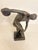 A nude athlete in a contorted pose on a pedestal preparing to throw a discus. Myron's skill to depict the movemnt of the...
