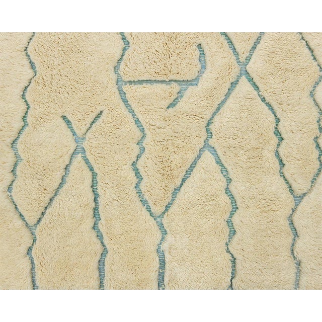 Playful hand-knotted wool rug featuring Aqua Blue geometric lines on a Cream background, adding a whimsical touch to any...