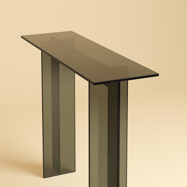 Assembled from Italian glass alone, the Naz is a slim, upright table made to sit against a wall that occupies a room...