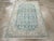 This mid-20th-century Persian Malayer throw rug presents a balanced geometric-floral composition across a muted blue...