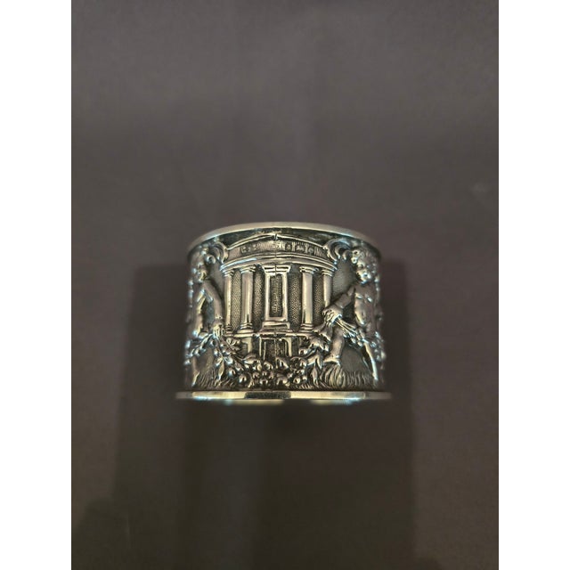 This is an exquisite vintage sterling silver napkin ring with two cherubs in an ornate repousse design. The other designs...