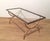 This beautiful rectangular coffee table is made of brass with a clear glass top surrounded by black lacquered edges. It is...