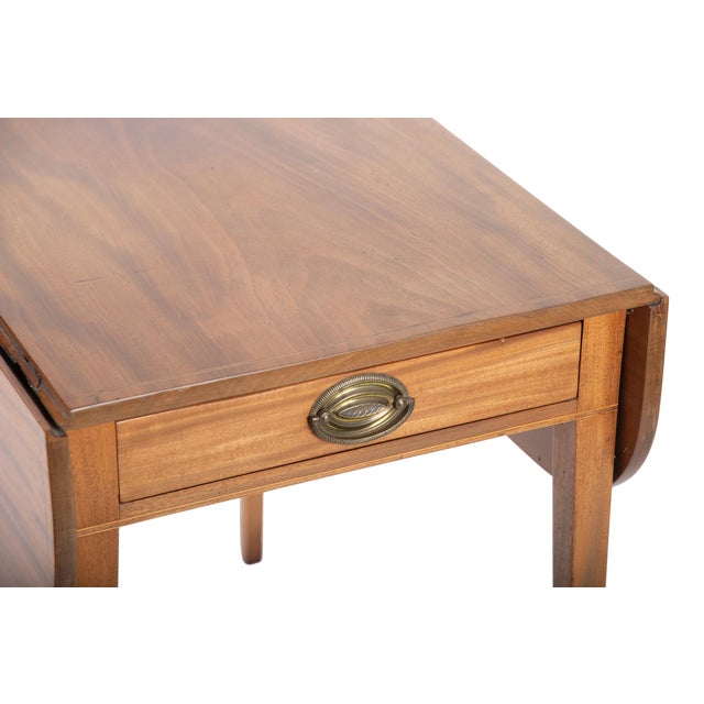 Finely crafted antique Pembroke table, cherry or mahogany with brass banded border detail. Twin drop leaves in demi-lune...