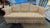 Design Plus Gallery presents a Formal Sofa with Kick Pleat Skirt and Camel Back Frame. The sofa has a light tan upholstery...