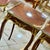 Elegant French-style side table featuring a sophisticated glass top that beautifully showcases the decorative artwork...