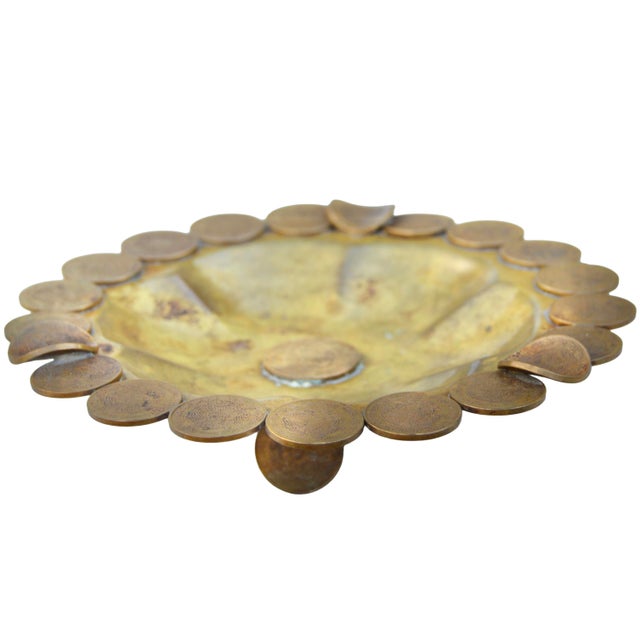 Unique antique Americana ashtray accent, showcasing a meticulously hand-hammered solid brass with elaborate coin...