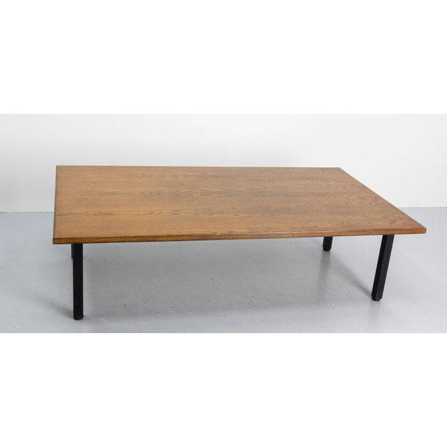 Massive oak Mid-Century Modern coffee table with metal frame and feet. The metallic frame support the the table top. The...