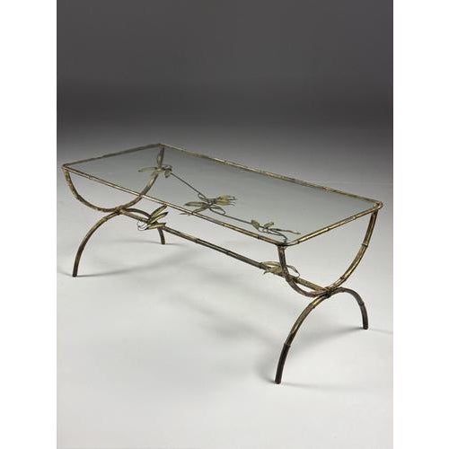Metal faux bamboo coffee table. Mid-20th-century coffee table/side table. Made of metal with faux bamboo finish. The glass...