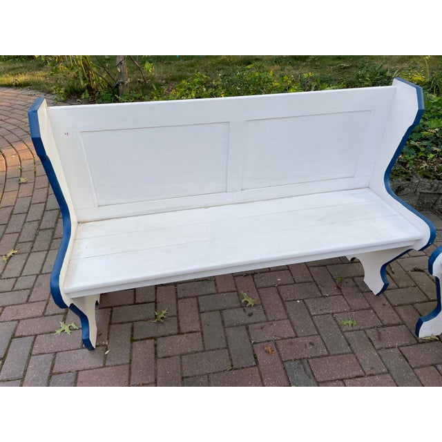 A handsome matched pair of vintage wooden booth benches. Originally part of a dinette set, these benches have the graceful...
