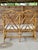 A stunning vintage rattan Chippendale fretwork settee showcasing an elegant geometric lattice back, gracefully curved...