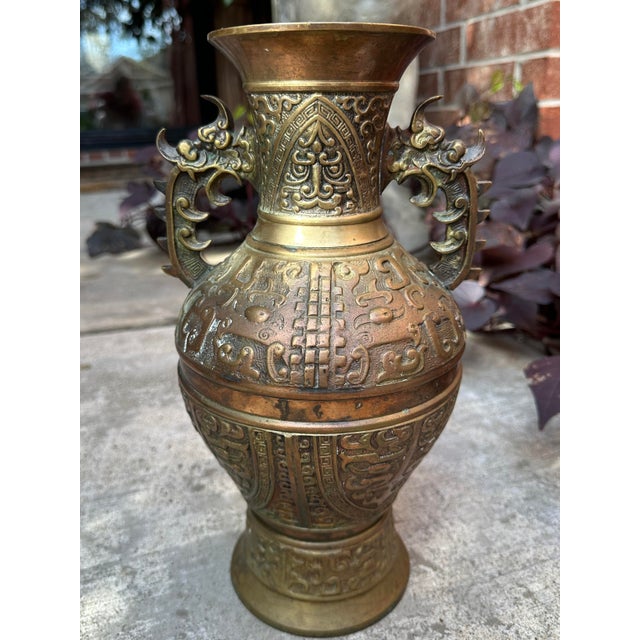 An exceptional late 19th-century Chinese altar or temple vase, cast in heavy brass and richly decorated in the archaistic...