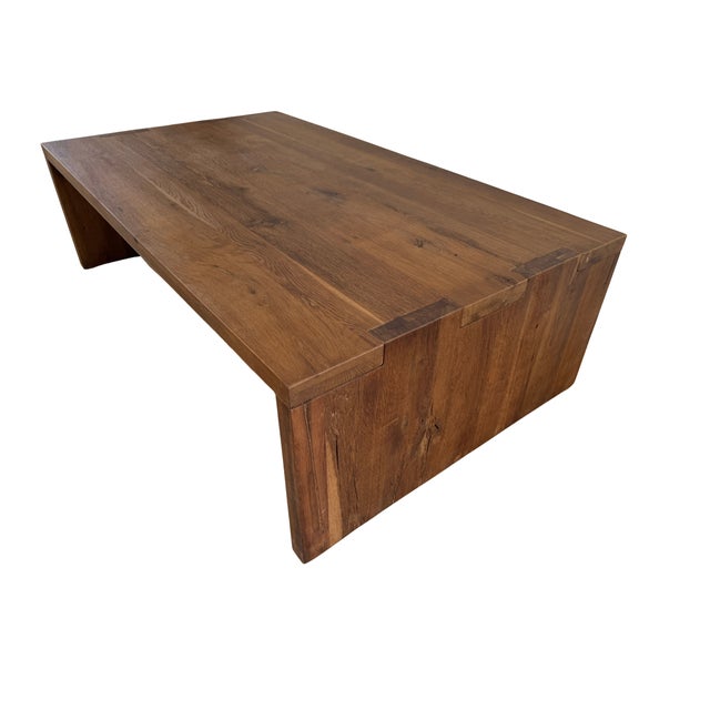 Embrace the seamless blend of functionality and rustic elegance with this striking coffee table from Restoration Hardware....