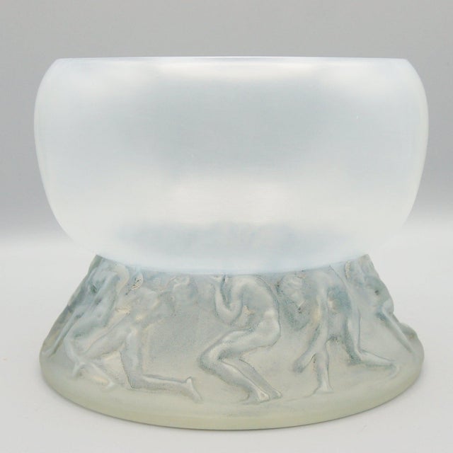 Lutteurs' An opalescent glass vase by René Lalique. A glass bowl raised above a band of moulded wrestlers. Designed in...