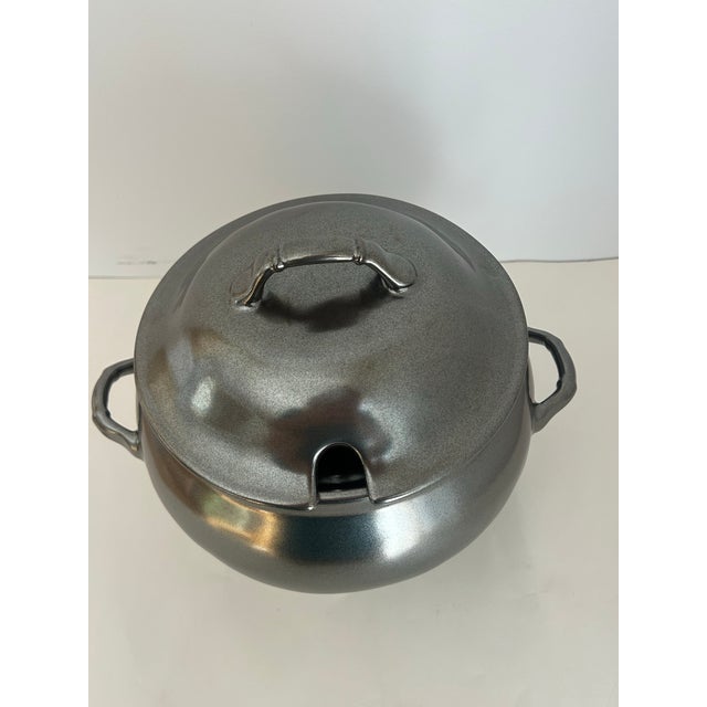 Juliska stoneware brushed pewter. 2 pieces. A lid and tureen. Have original box. Holds 4 quarts. Cut out in lid for a ladle.