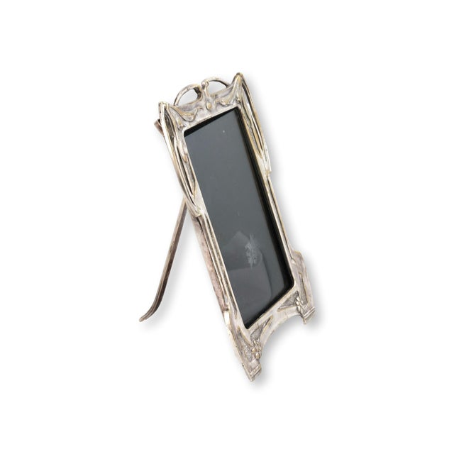 Early 20th century English silverplate picture frame in a classic Art Nouveau design, featuring flowing organic lines,...