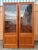 A Pair of Vintage Mid-Century Modern Danish Lighted Curio Display Cabinets by Sun Cabinet Co. Circa 1970s Features a clean...
