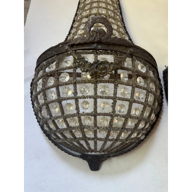 A stunning pair of antique French basket sconces, ready to ship. These fixtures exude timeless old-world charm while...