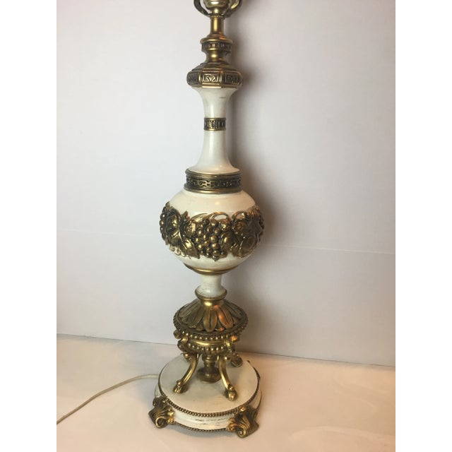 Elegant Hollywood Regency ivory and gold table lamp. Grape leaves, Greek key border, acanthus leaves and more! Circa 1950s...