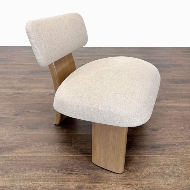 Relax in style with this Maiden Home Attributed lounge chair. Features a wide, cushioned seat and backrest in soft cream...