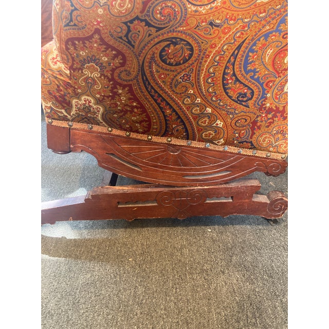 Eastlake platform rocking chair. Beautifully upholstered in an orange, red and blue paisley fabric.