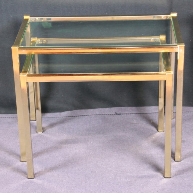 Beautiful minimalist pair of golden nesting table, by the Belgium Editor 'Belgo-Chrome", in Mid-Century style, at the end...