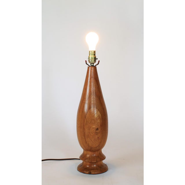 Minimalist vintage hand-turned wood table lamp, from the mid-century modern era, characterized by its simple clean lines,...