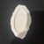 The tray features intricate floral and scroll designs surrounding the central cameo and is commonly used for trinkets or...