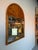 Striking large-scale vintage wall mirror by Chapman featuring a beautifully carved pine wood frame with an architectural...