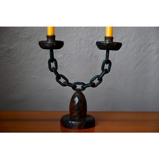 Raw and unique, this two-candle candelabra reflects the spirit of an era when craftsmanship celebrated its imperfections...
