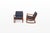 An elegant pair of vintage rocking chairs designed by ole wanscher for cado, denmark. The warm wooden frames feature...