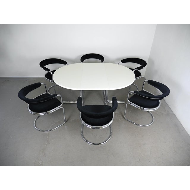 Dining set from the 1970s by the German manufacturer Läsko. The white, round dining tabletop is supported by a chrome-...
