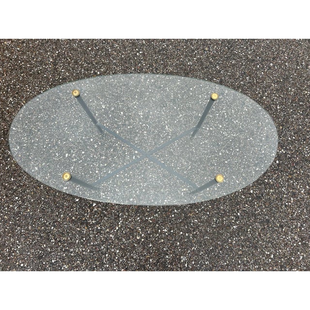 Glass top coffee table with brass base, black lacquered, 1950s.
