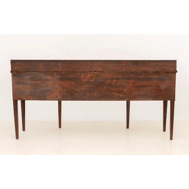 A handsome George III mahogany sideboard dating to circa 1800, distinguished by beautifully figured and bookmatched...