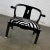 Stunning vintage Ming style yoke back black lacquered low chair with square brass sabots in the style of James Mont. Re-...