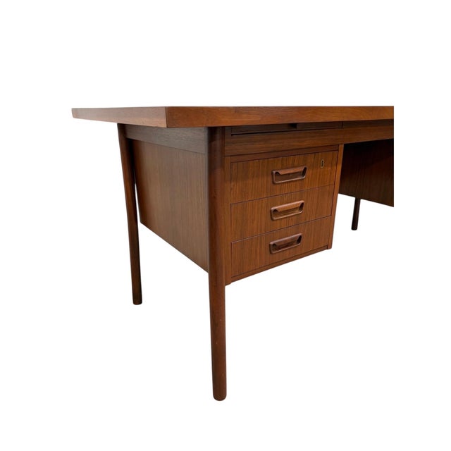 A handsome Mid-Century Danish Modern teak executive’s desk, circa 1960s, recently refinished to restore the richness and...