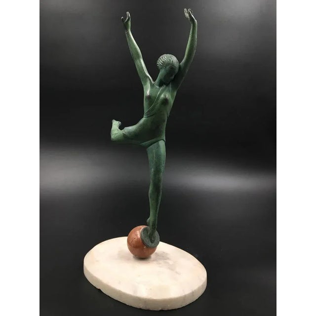 Art Deco female figurine "Olympia" gracefully balancing on a ball. The sculpture is made of spelter and has been placed on...