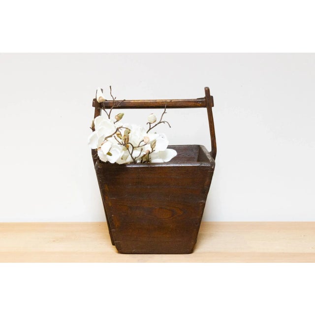 Antique Chinese wooden basket! Its weathered wood, kissed with a warm aged patina,whispers tales of countless harvests,...