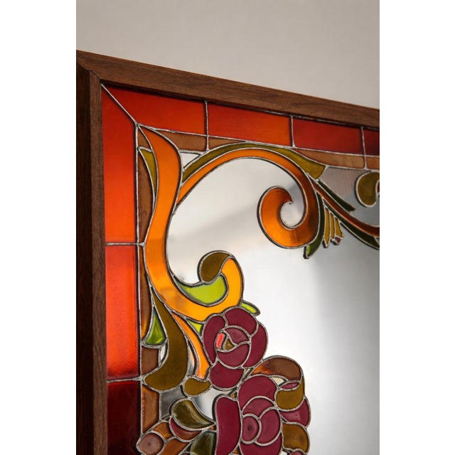 Incredibly striking vintage Artglas mirror featuring reverse-painted glass in a richly saturated palette of amber, rust,...