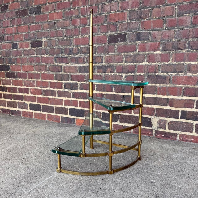 This is a gorgeous faux bamboo brass and glass step shelf believed to be made by Mastercraft. Its design replicates...