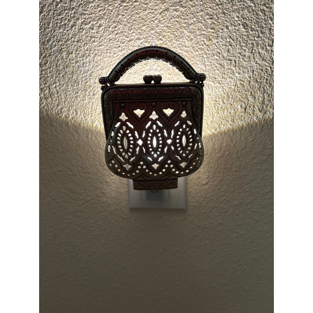 This night light is made of pewter and works just great since we purchased the dusk to dawn setting light fixture and...