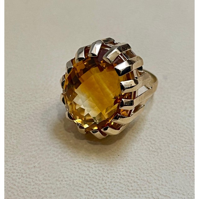 Approximately 42 Carat Natural Oval Citrine Cocktail Ring in 14 Karat Yellow Gold, Estate This is a ring which has a...