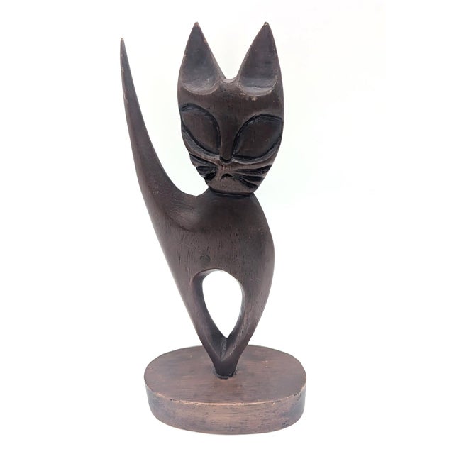 Offered is an artisan crafted handcarved wood cat figurine likely made in the Philippines circa. 1950s to 1960s. It...